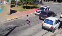 Boy crosses the street and gets hit over by a police car