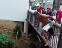 Man slips into a river head first from a bridge and gets knocks out underwater!