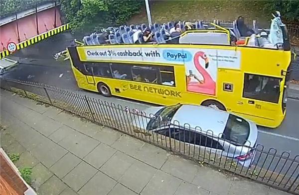 Double-decker bus slams into low bridge in Manchester, ripping off roof and injuring multiple passengers - United Kingdom