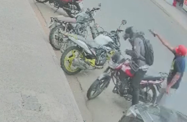 Delivery rider shot in Portoviejo's busy commercial district - Ecuador