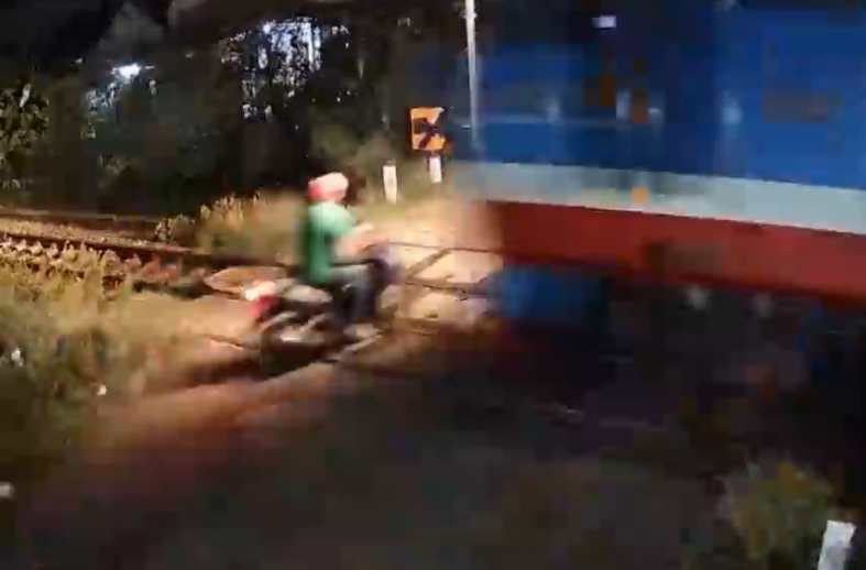 Impatient motorcyclist ignores all warnings and is hit by Train at crossing - Vietnam