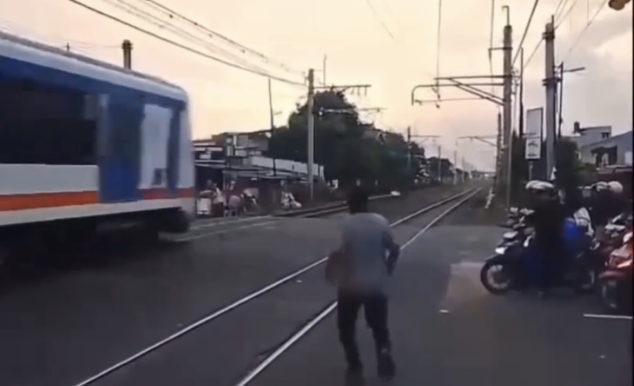 Man hit by oncoming train after attempting to cross tracks moments after another train passed - Indonesia